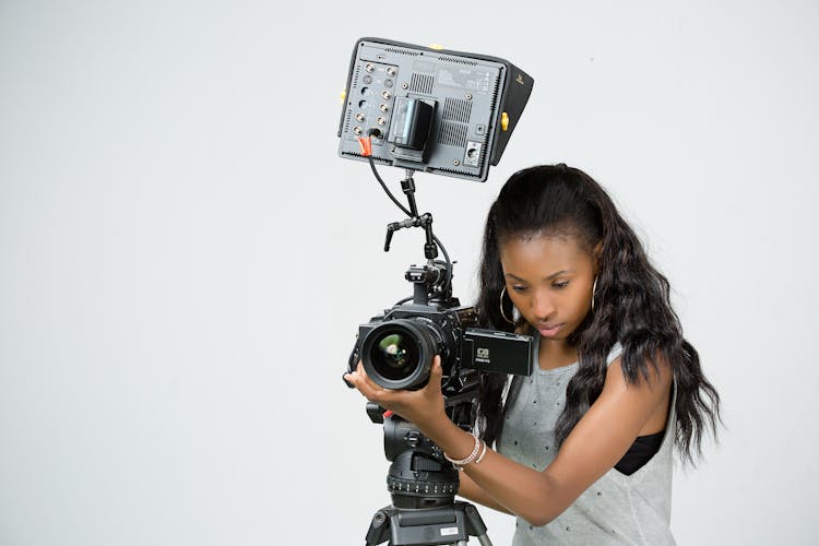 Young Woman Operating A Professional Camera 