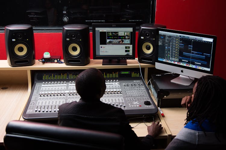 Men Recording Music In Modern Studio