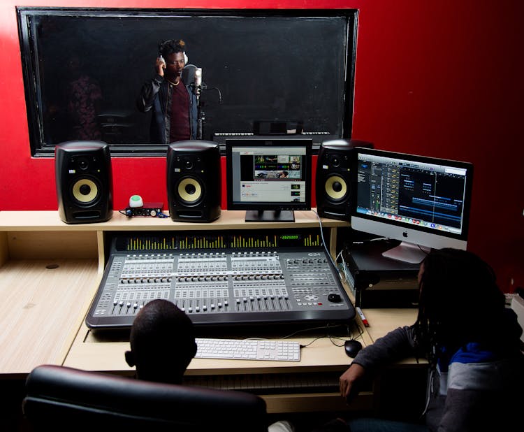 Men Recording Music In Modern Studio