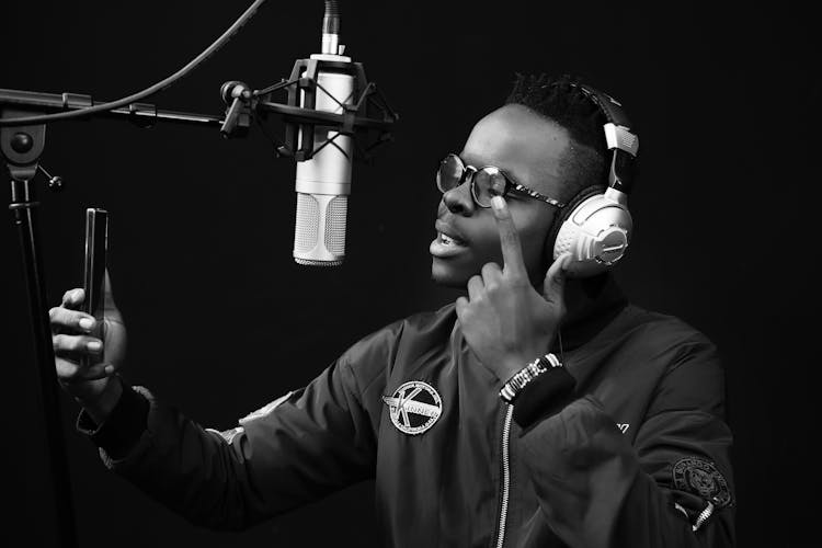 Black And White Shot Of A Man Recording A Song