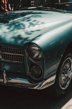 A close-up view of a vintage classic car with retro design and chrome details, showcasing elegance.