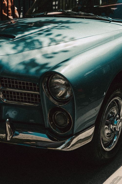 Free A close-up view of a vintage classic car with retro design and chrome details, showcasing elegance. Stock Photo