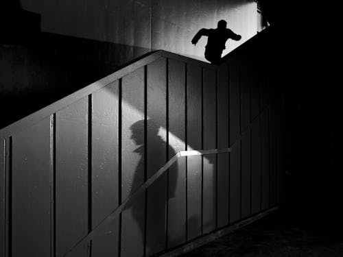 Shadow of a Man with another Running up Staircase