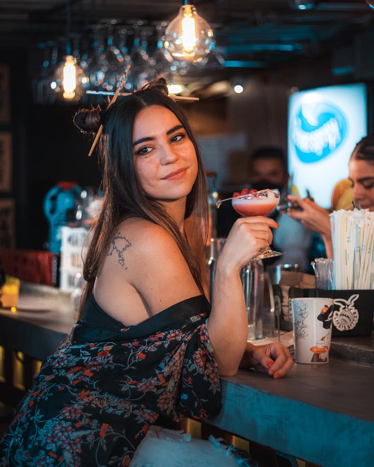 A Woman Holding A Glass Of Cocktail Drink
