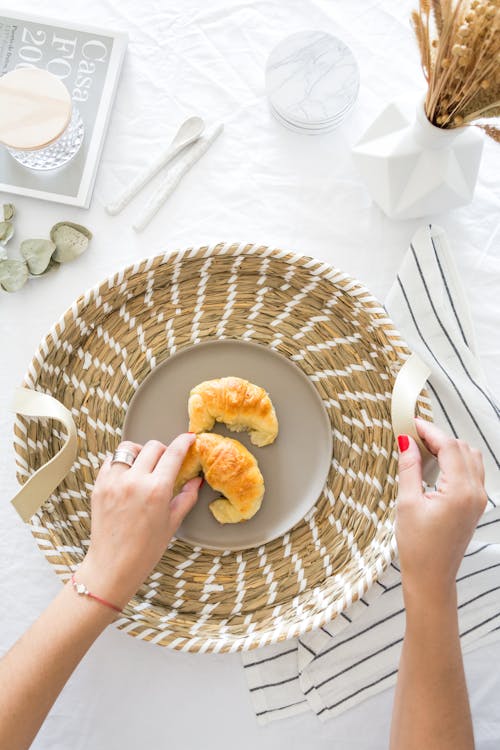 Woman Putting Homemade Croissants in Basket