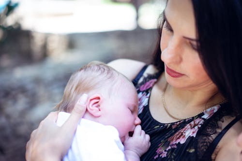 Free A Woman Carrying Her Baby Stock Photo