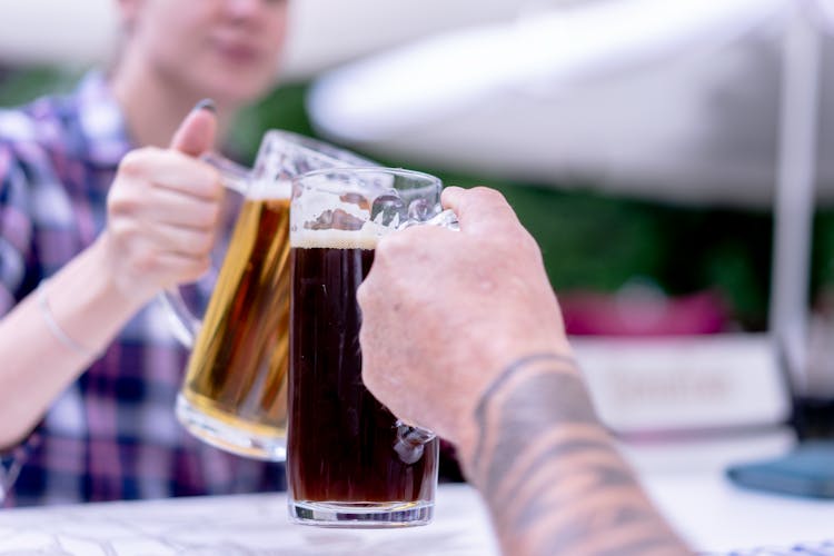 People Clinking Of Beer Glasses