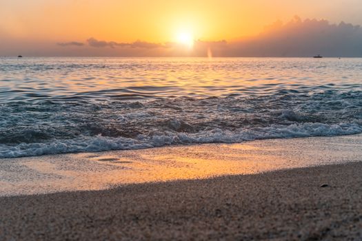 Beautiful sunset at Alanya beach, Turkey, with golden light reflecting on the waves.