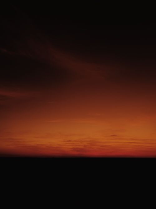 Free Captivating orange gradient sky during sunset, perfect for vibrant nature backgrounds. Stock Photo