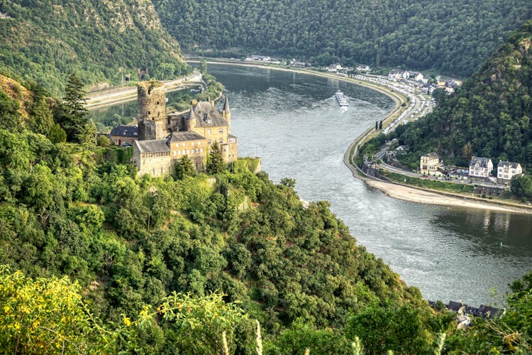 Old Castle On Hill In Mountains Landscape With River