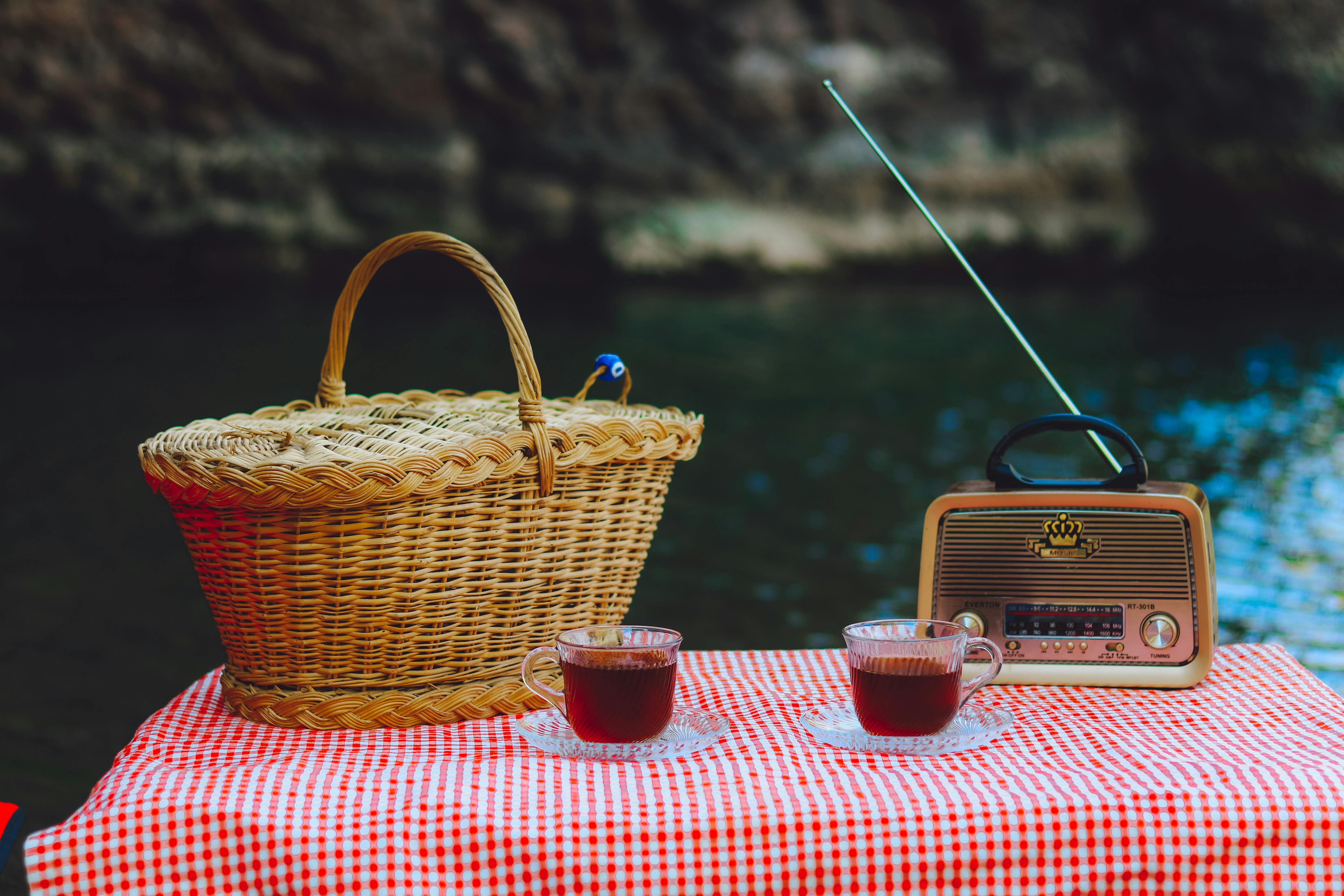 Tea, Picnic Basket and a Radio on the Table · Free Stock Photo