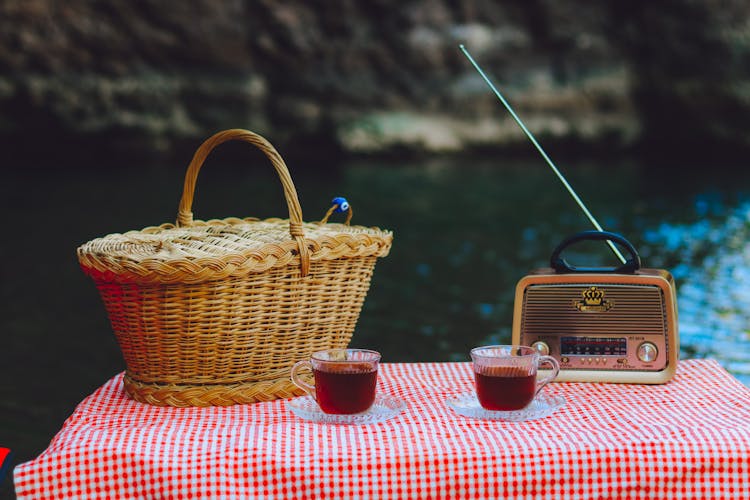 Tea, Picnic Basket And A Radio On The Table 