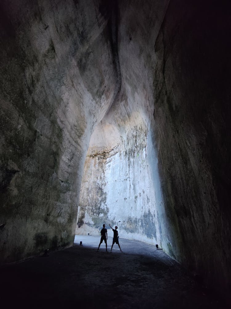 Silhouette Of 2 Person Inside The Cave