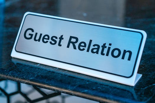 Close-up of a guest relation sign on a granite reception desk, ideal for hospitality services.