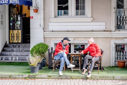 Couple Sitting by a Cafe and Talking