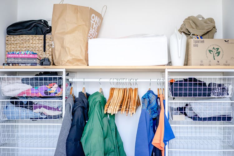 Clothes On The Hangers In An Open Wardrobe 