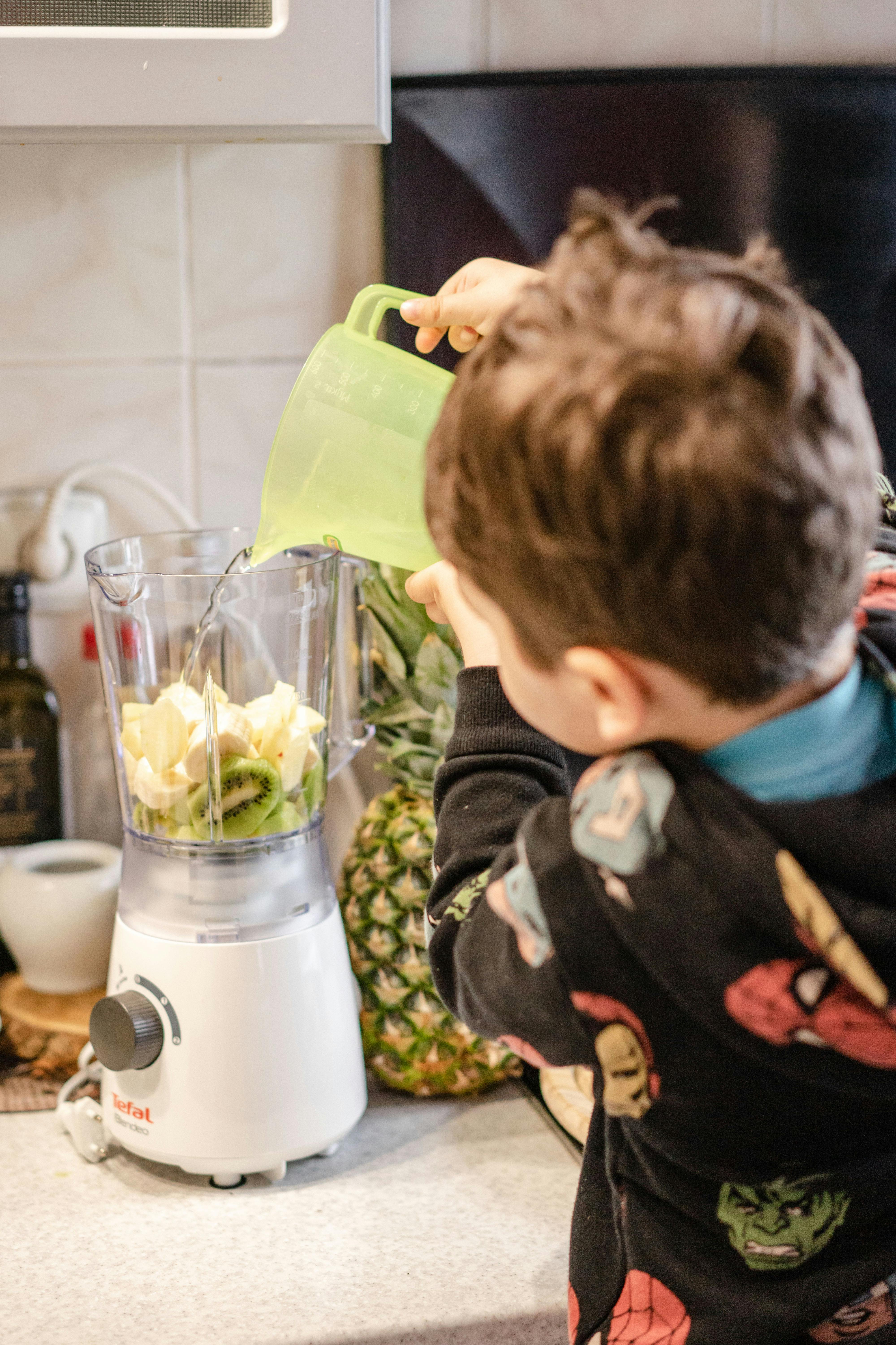 Person making cherry smoothie with a blender isolated Stock Photo