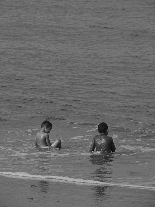 Grayscale Photo of Kids at the Beach