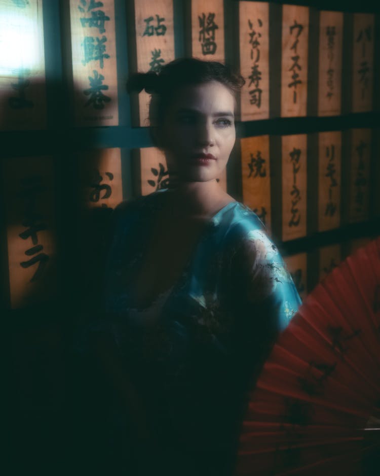 Portrait Of A Woman In Japanese Clothes And Script On A Wall