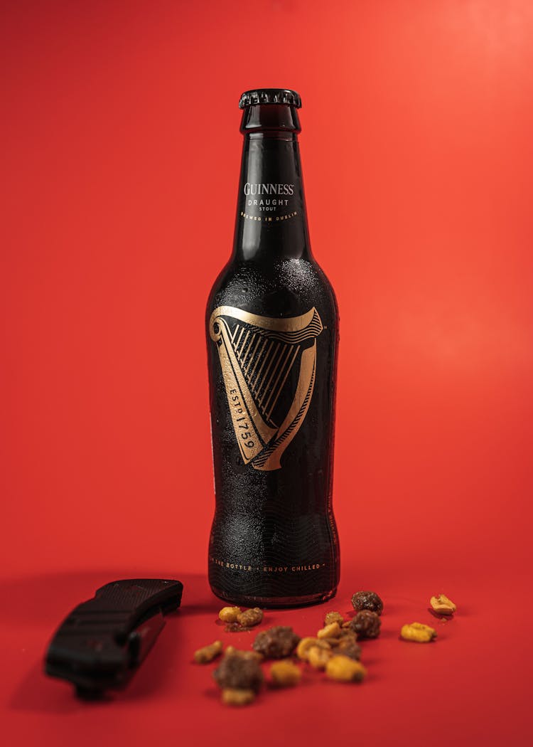 Guinness Beer Bottle On Red Surface