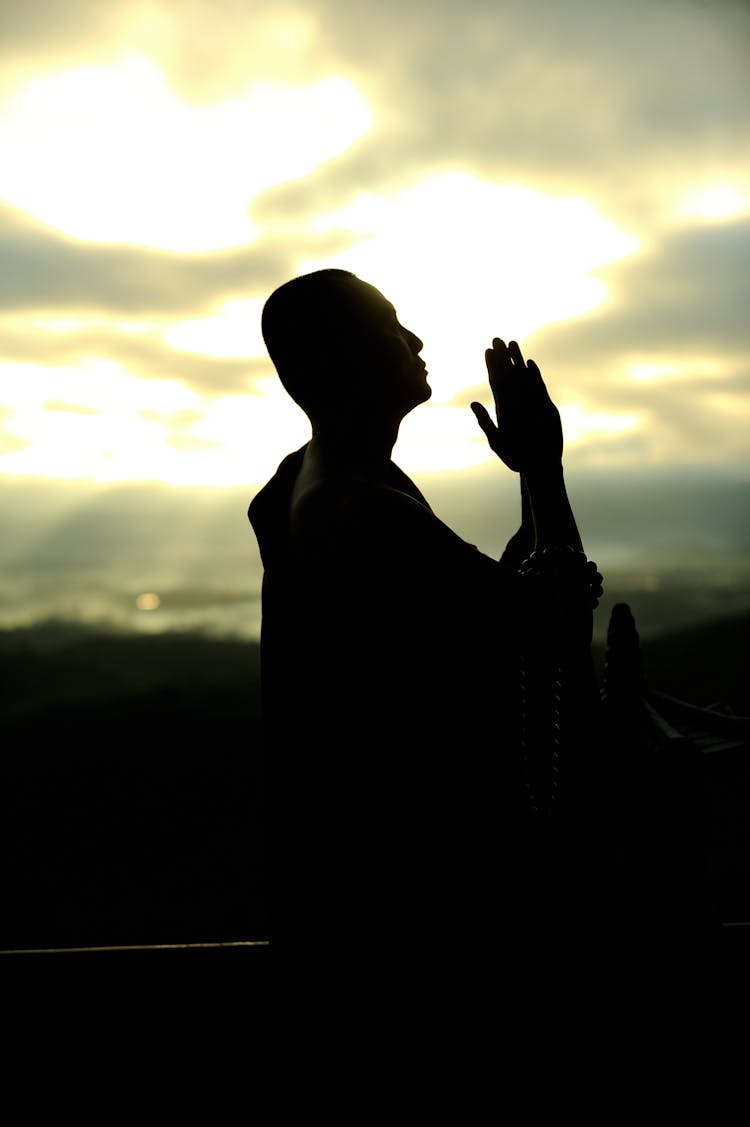 Silhouette Of Man Praying