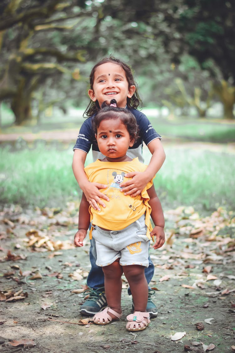 Cute Little Kids Standing On A Park