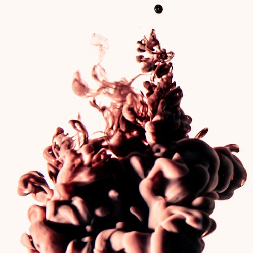 Brown Liquid Paint Mixed with Water in Close-up Photography