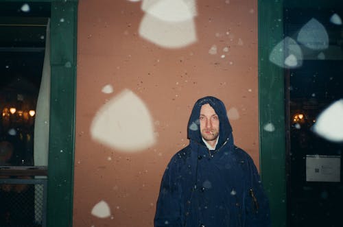 Man Wearing Hoodie in Rain