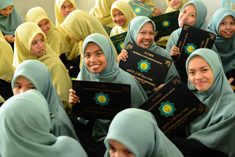 Group Of Young Girls Holding Their Graduation Diplomas 