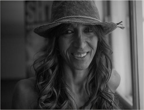 Grayscale Photo of Woman Wearing Hat
