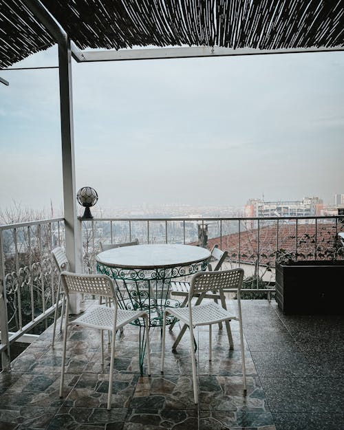 White Metal Table and Chairs on Balcony