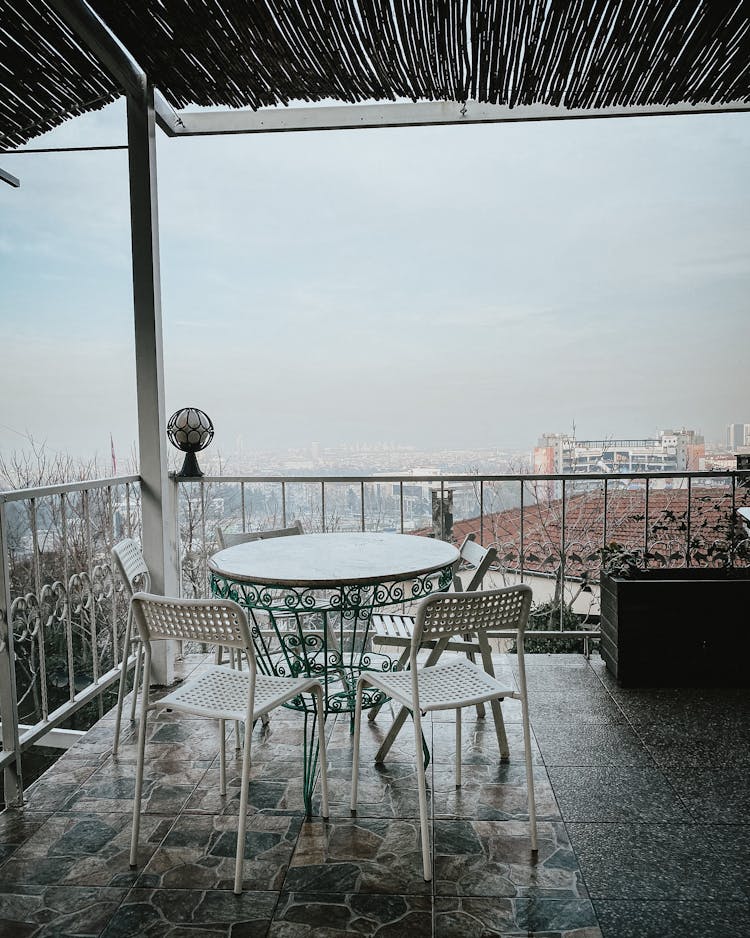 White Metal Table And Chairs On Balcony