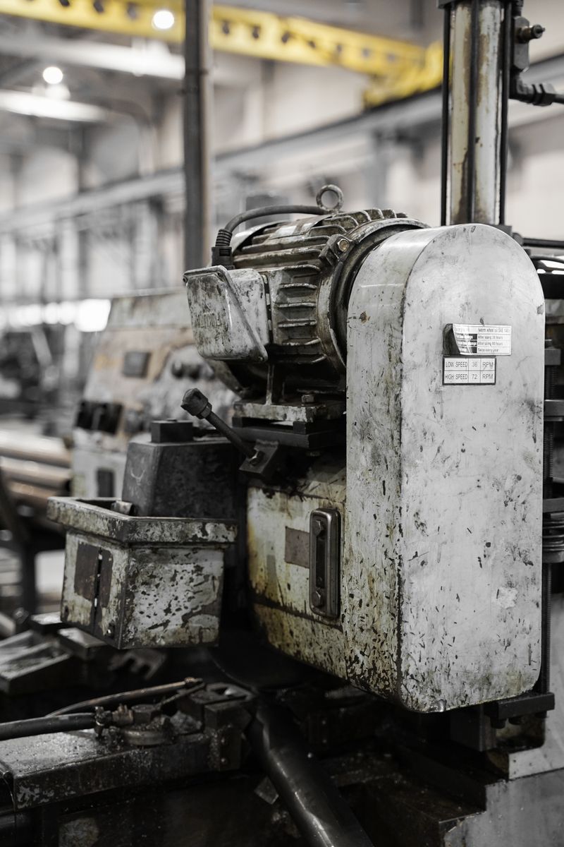 Greasy industrial machinery in a factory showcasing heavy equipment and metalwork