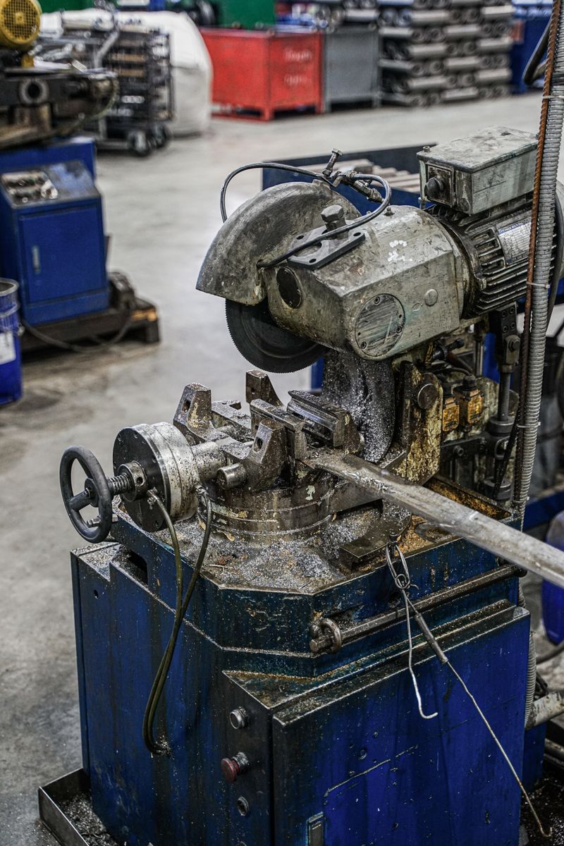 Industrial machine cutting pipes in a factory
