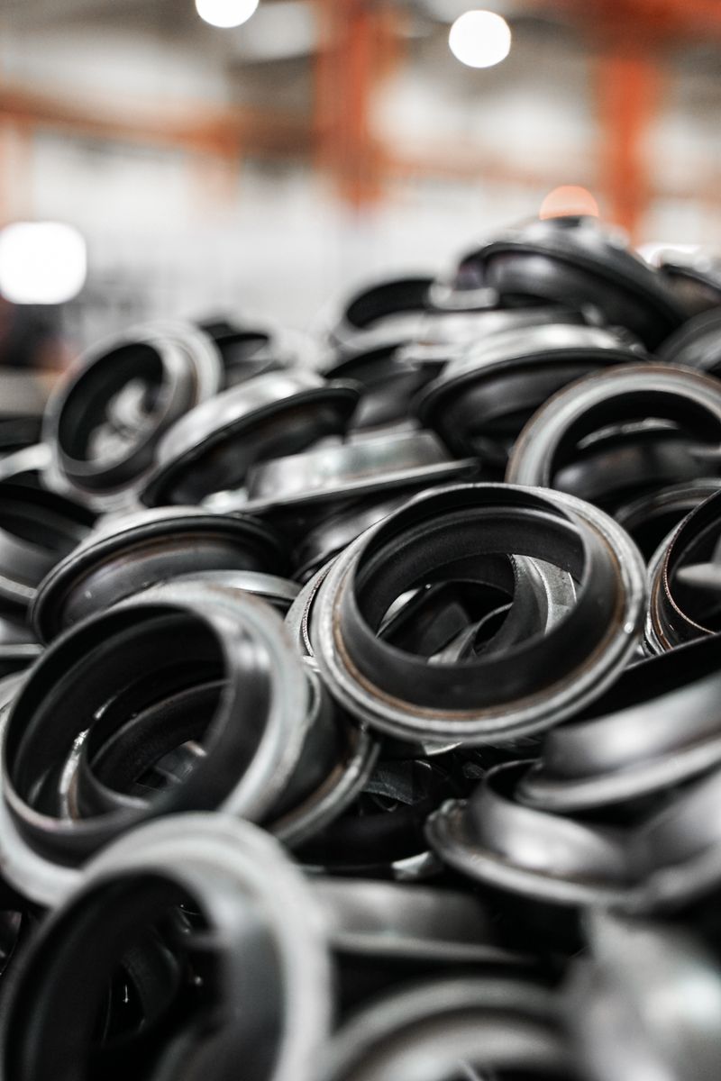 Close-up of a pile of black metal rings in a manufacturing environment