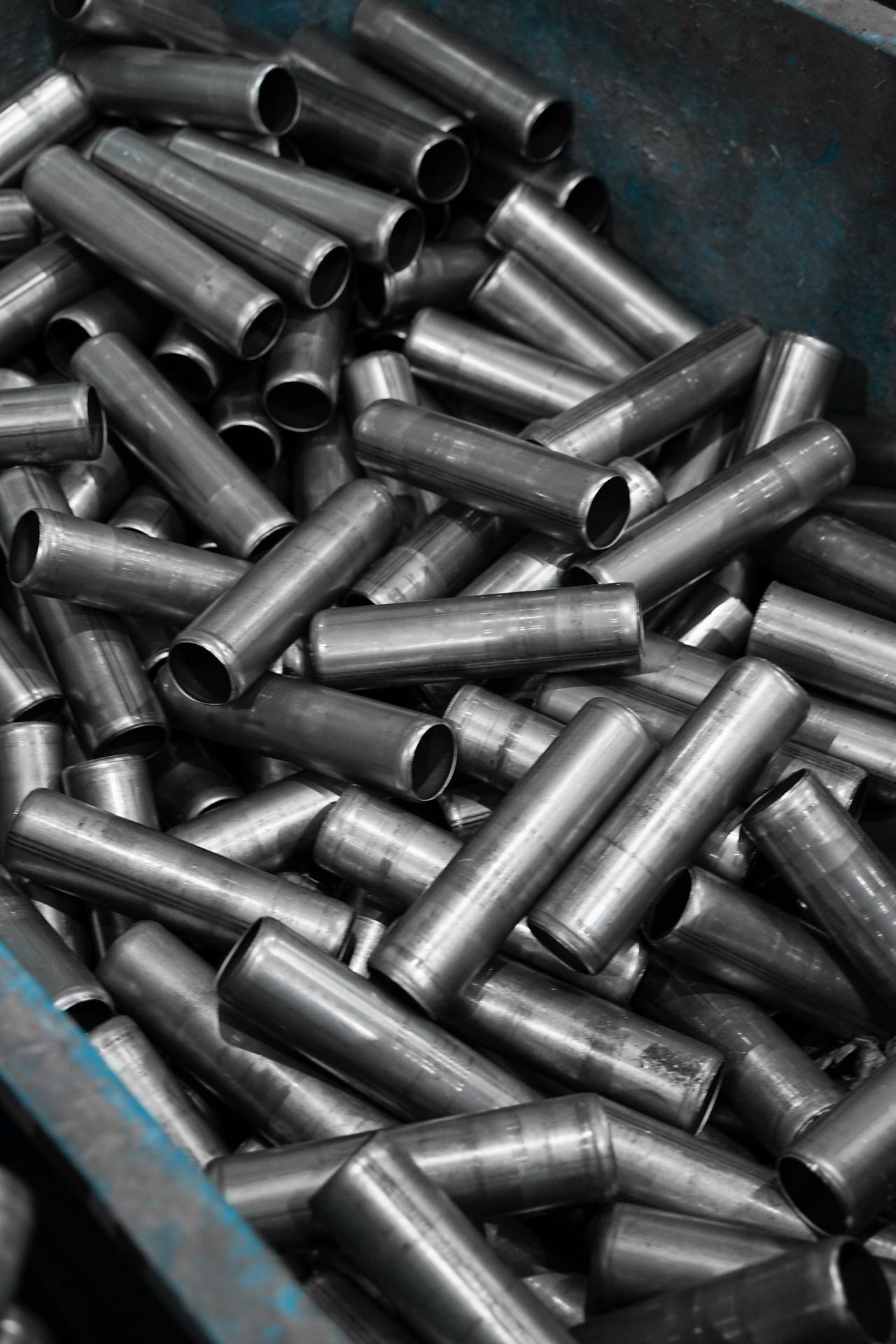 Stainless steel pipes stacked in an industrial container