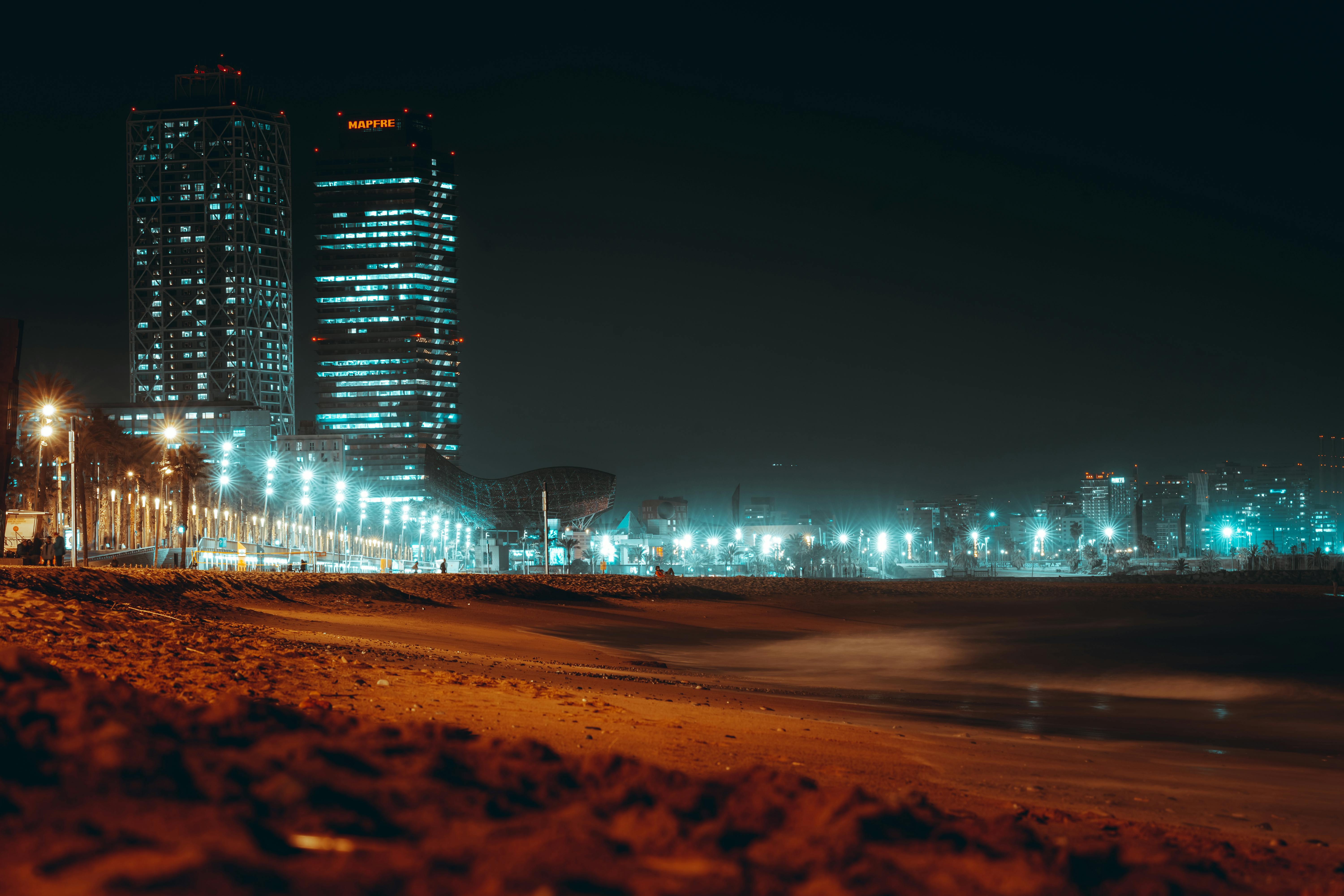 illuminated modern buildings on the coast in barcelona spain