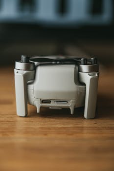 Detailed close-up image of a compact folded drone on a wooden table.