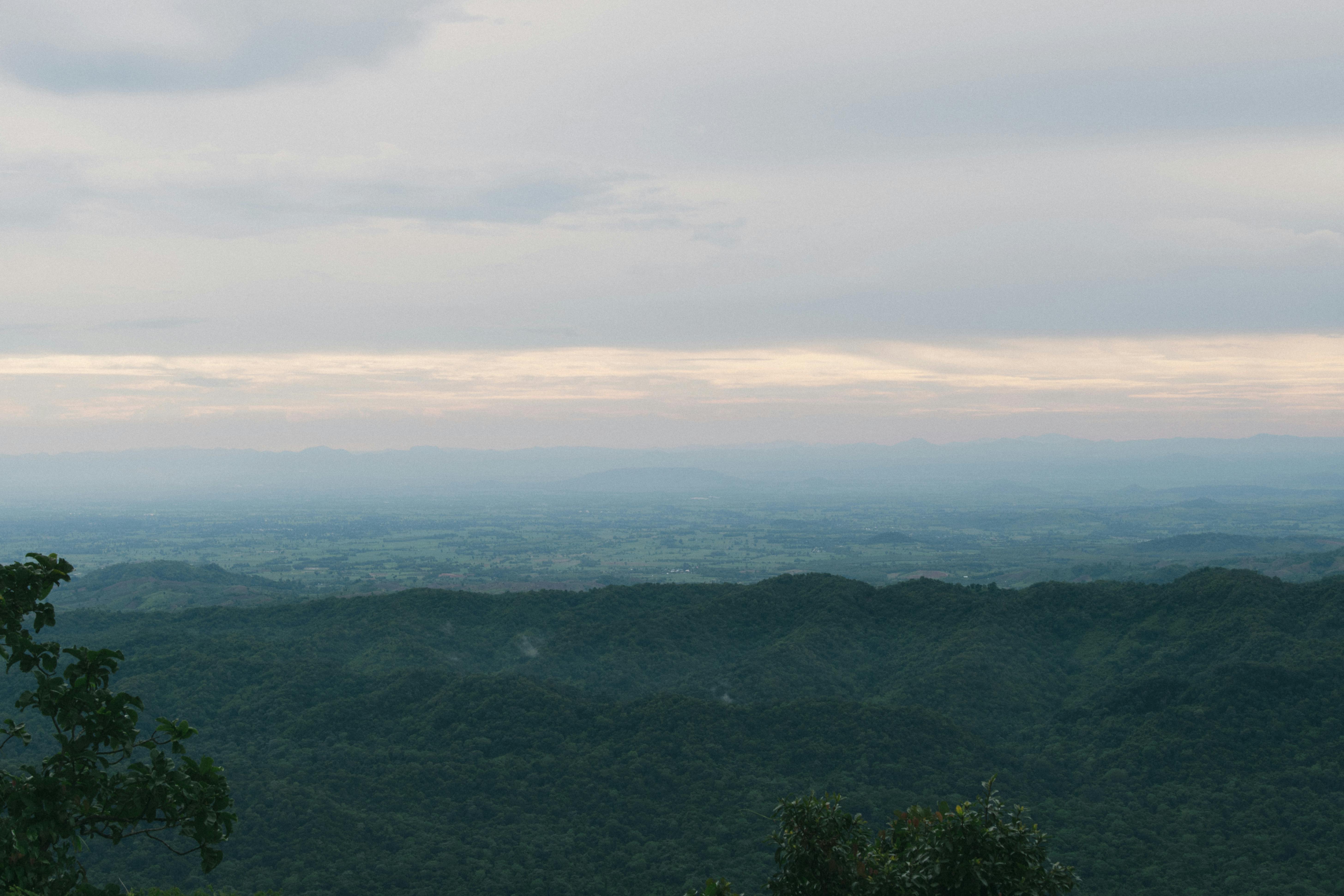 Aerial view of lush green hills and valleys in Tambon Ban Rai, Thailand.