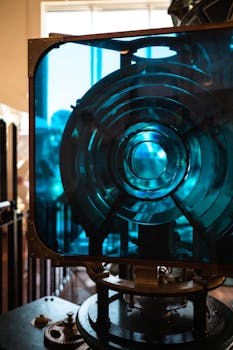 Detailed view of an antique Fresnel lens with blue glass, showcasing its intricate design.