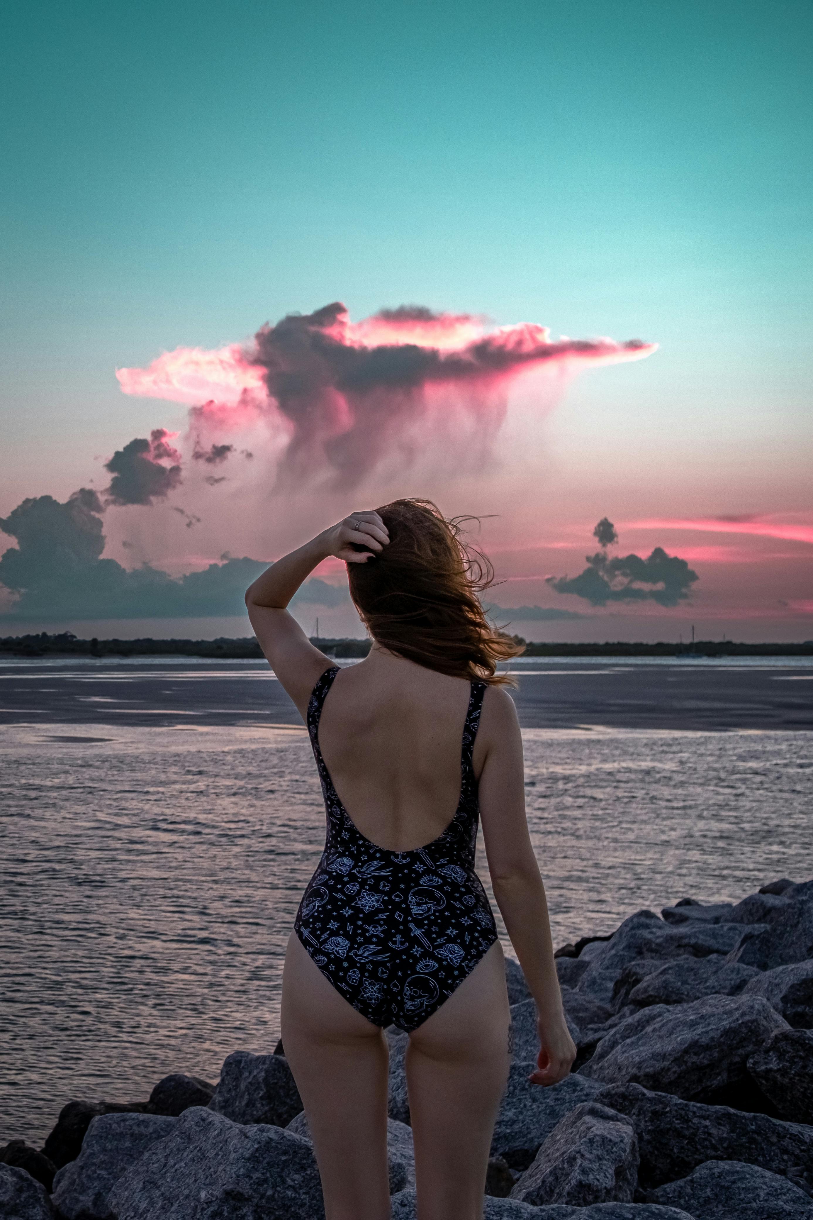 Back View of Woman in Black Backless Swimsuit Standing on Shore