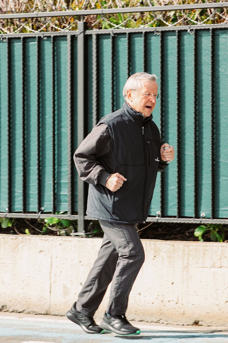 Elderly Man Jogging On A Street