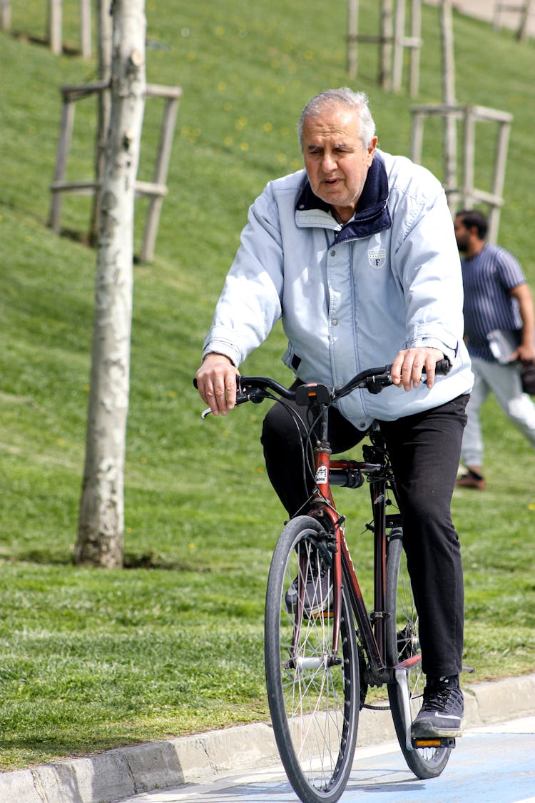 Senior Man Riding A Bicycle