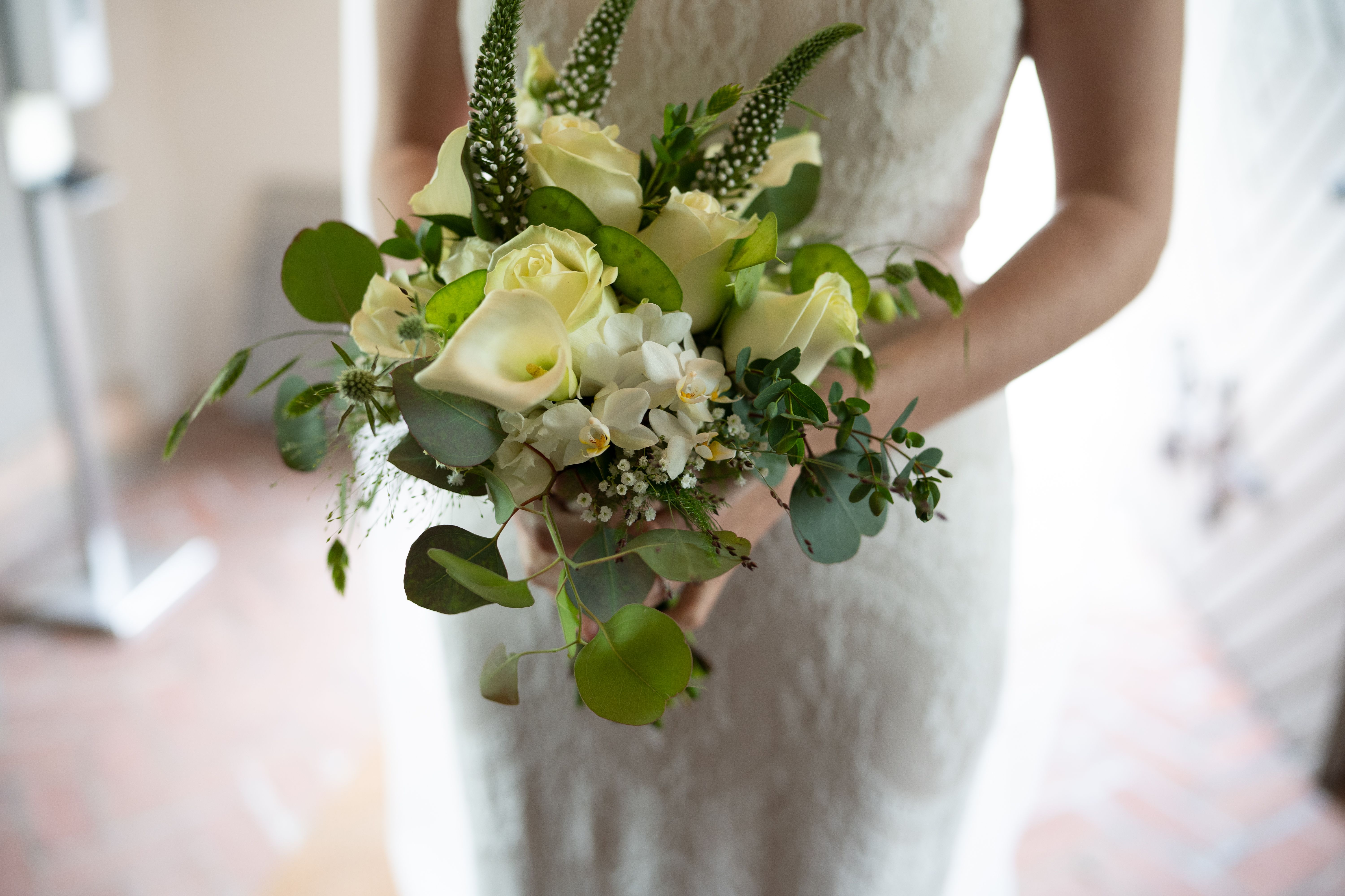 Woman in White Dress Holding a Bouquet of Flowers · Free Stock Photo