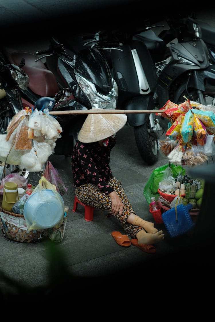 Woman In Conical Hat Selling On Ground On Street