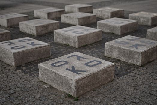 Modern art installation featuring concrete blocks with letters in Wrocław, Poland.