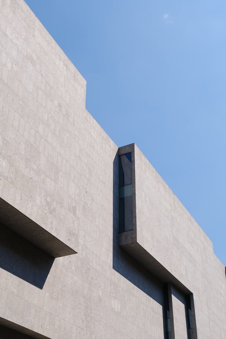 Stone Modern Building On Blue Sky