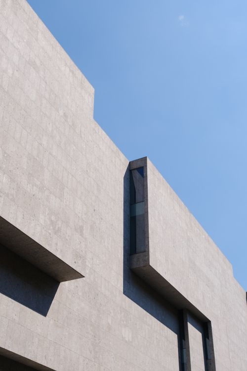 Free A contemporary building with a geometric design set under a clear blue sky. Stock Photo