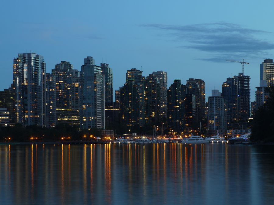 Vancouver skyline reflecting on calm water at dusk