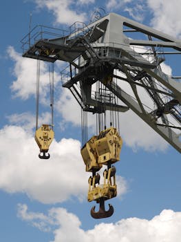 Close-up of a crane at Montreal port highlighting machinery details under a blue sky.